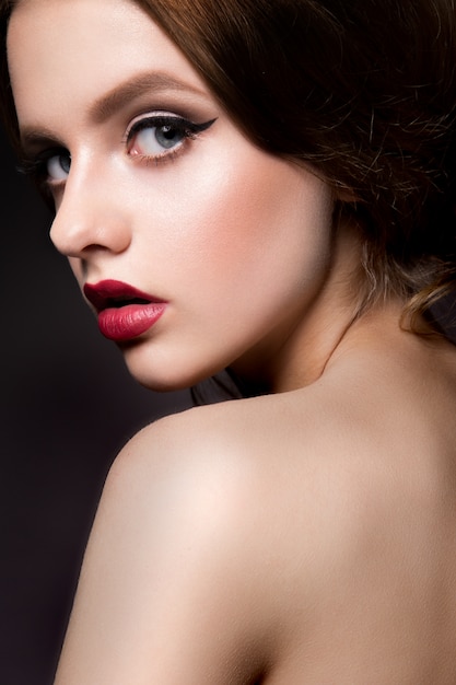 Close-up portrait of beautiful woman with bright make-up