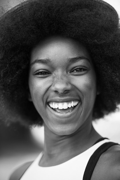 Close up portrait of a beautiful young african american woman smiling and looking up on a beautiful sunny day