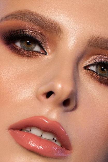 Close up portrait of a beautiful young model with professional makeup and perfect skin