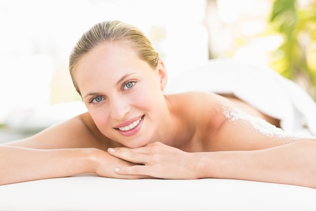 Close up portrait of a beautiful young woman on massage table