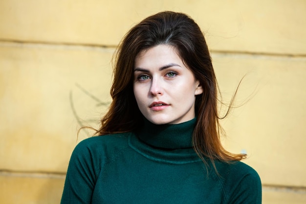 Close up portrait of a beautiful young woman smiling and looking at camera