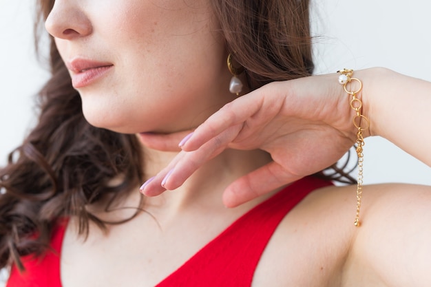 Close-up portrait of beautiful young woman with elegant hairstyle and luxurious jewelry