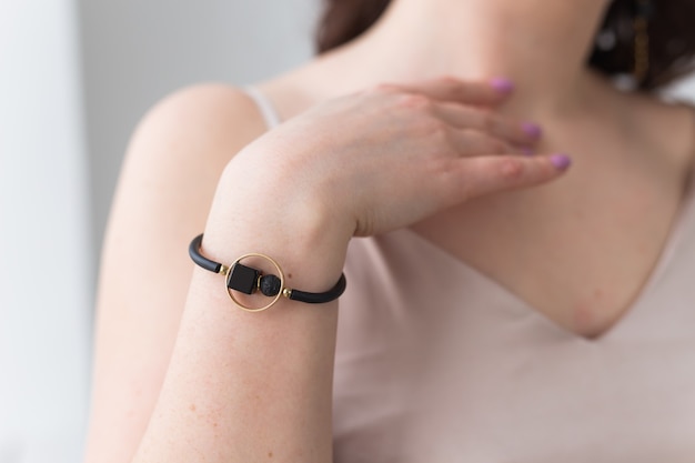 Close-up portrait of beautiful young woman with elegant luxurious jewelry and bijouterie.