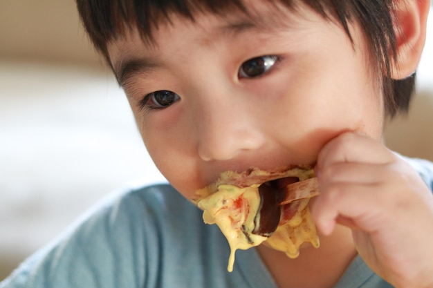 Close-up portrait of boy eating food