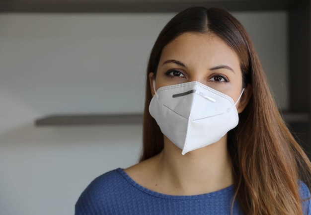 Close up portrait of brazilian Caucasian woman with face mask indoors