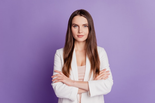 Close up portrait of confident cool lady crossed hands wear formal suit posing on purple wall