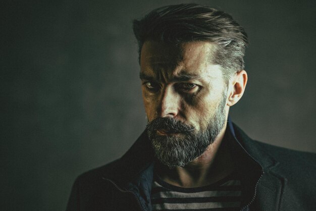 Close-up portrait of confident man against wall