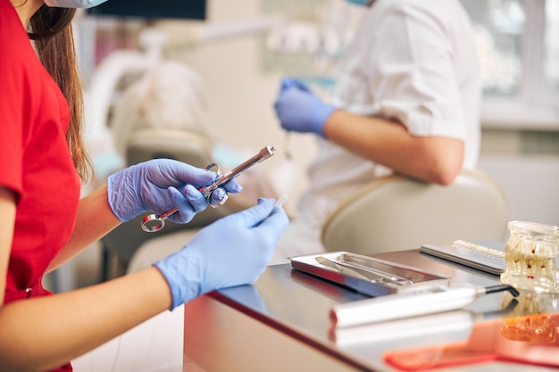 Close up portrait of doctor holding in her dentist hand carpool syringe for local anesthesia