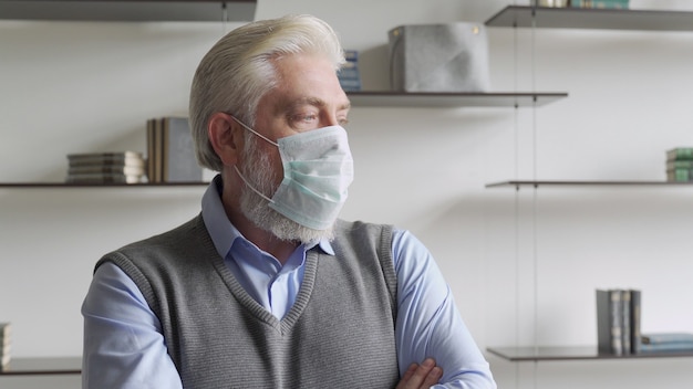 Close up portrait of elderly man in medical face mask