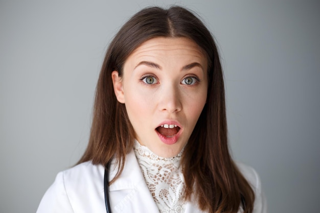 Close-up portrait of a female doctor on a gray background