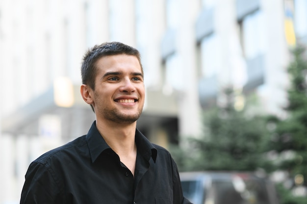 Close up portrait of a handsome young man in a black shirt