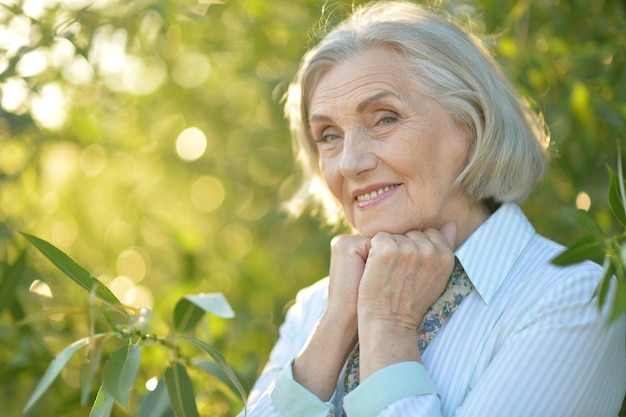 Close up portrait of happy beautiful elderly woman posing outdoors