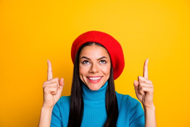 Photo close-up portrait of her she nice attractive cute glad confident cheerful girl pointing up copy space advert good solution decision isolated over bright vivid shine vibrant yellow color wall