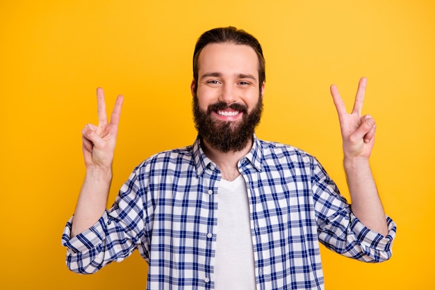 Close-up portrait of his he nice attractive cheerful cheery funky brunette bearded guy in checked shirt