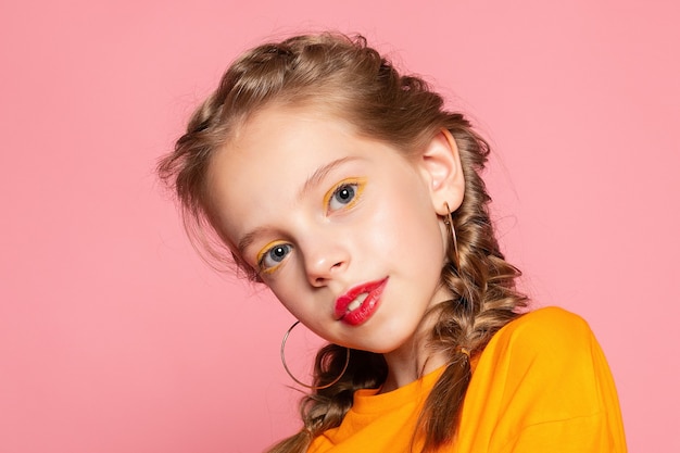 Close-up portrait of lovely sweet curious cheerful cheery smart clever girl isolated pink pastel color wall