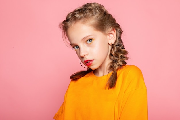 Close-up portrait of lovely sweet curious cheerful cheery smart clever girl isolated pink pastel color wall