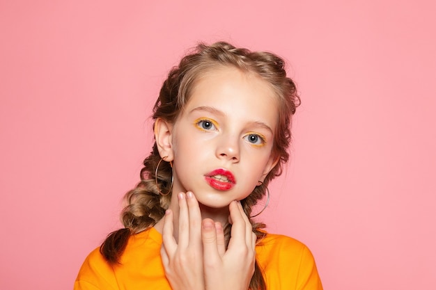 Close-up portrait of lovely sweet curious cheerful cheery smart clever girl isolated pink pastel color wall