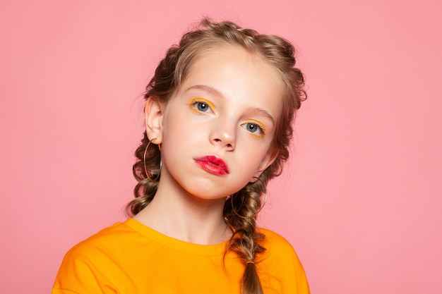 Close-up portrait of lovely sweet curious cheerful cheery smart clever girl isolated pink pastel color wall