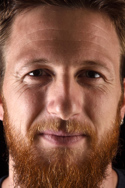 Close up of a portrait of man on black