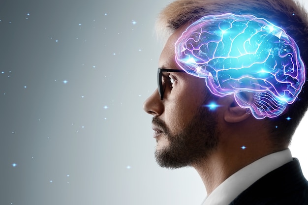 Close up portrait of a man from the side in profile and a hologram of a working brain. The concept of intelligence, brain work, thought process.