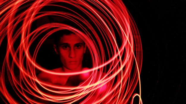 Photo close-up portrait of man with light painting at home