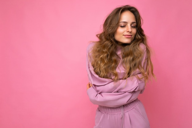 Close-up portrait of nice-looking attractive lovely lovable pretty cute winsome gorgeous cheerful cheery wavy-haired blonde woman isolated on pastel color background wearing stylish clothes.