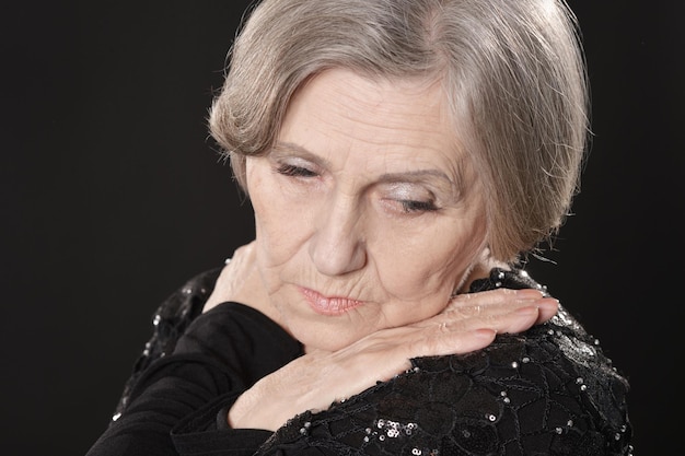 Close up portrait of sad senior woman at home