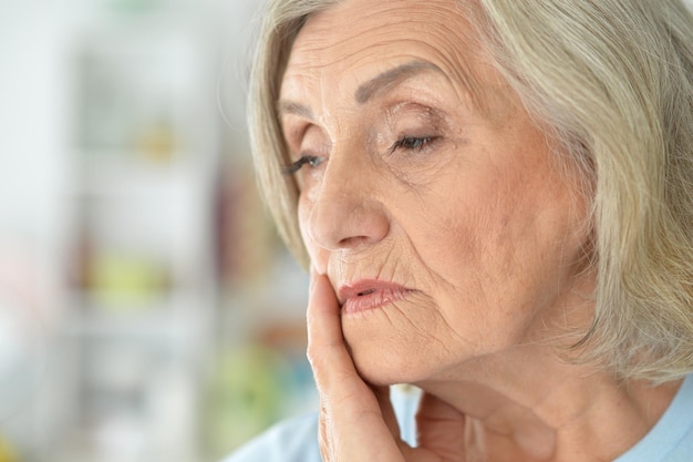 Close up portrait of sad senior woman