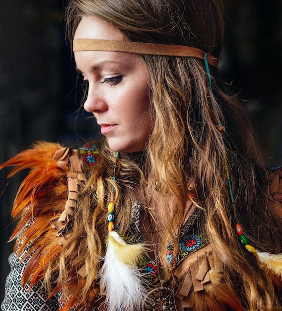 Close up portrait of shamanic female with indian feather