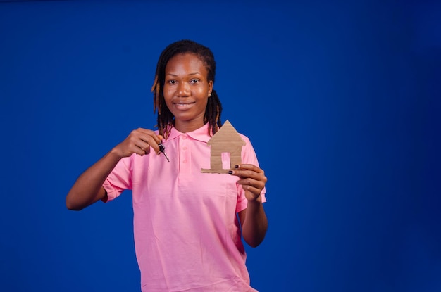 Close up portrait of a smiling cheerful woman showing house keys