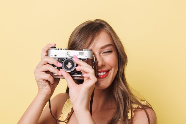 Close up portrait of a smiling young girl taking picture