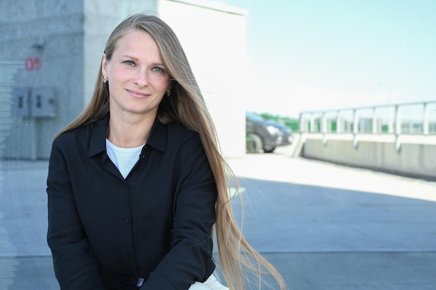 Close up portrait of smilling 35 years old woman with long natural hair Flying blonde hair on the wind Vertical photo