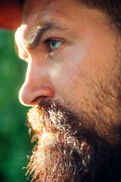 Close up portrait of stylish handsome young man in rural village.