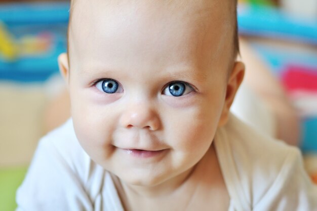 Close-up portrait of sweet blue-eyed baby