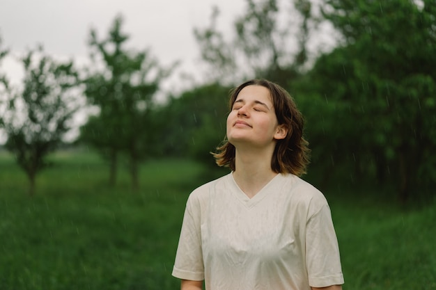 Close-Up Portrait Of Teenager Girl. Warm Summer Rain In Outdoors.