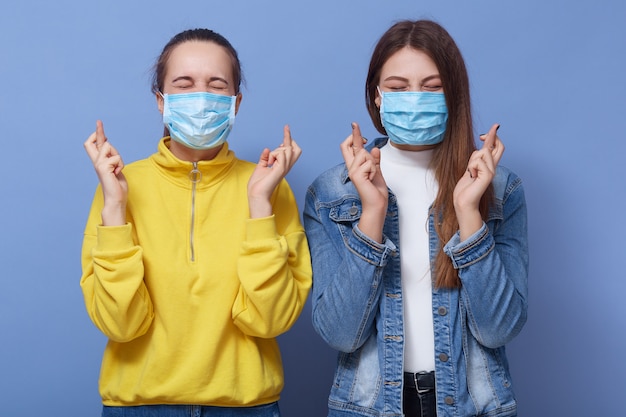 Close up portrait of two women wearing casual outfit and health masks