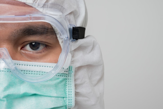 Close-up of portrait of virologist with PPE suit