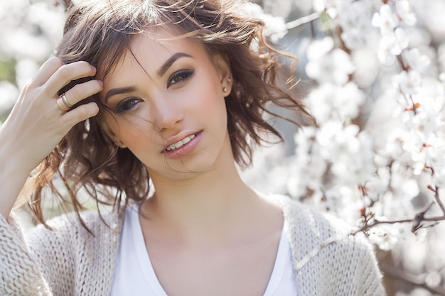 Close up portrait of young beautiful woman on spring  . Attractive young girl with flowers. Spring make up model.