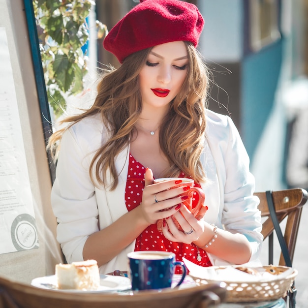 Close-up portrait of young beautiful woman wearing red beret. 