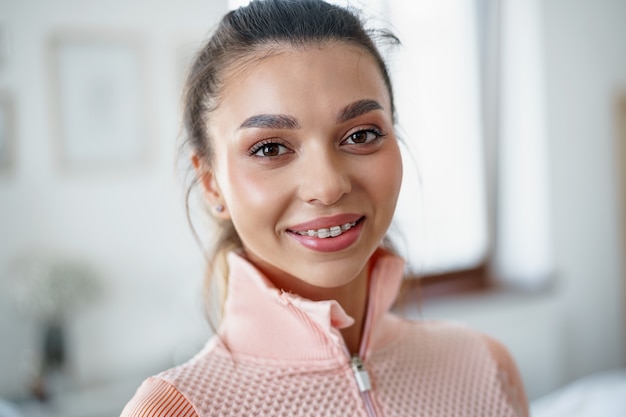 Close up portrait of a young fit girl in orange sportsuit