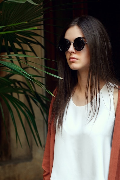 close up portrait young girl in white shirt and sunglasses