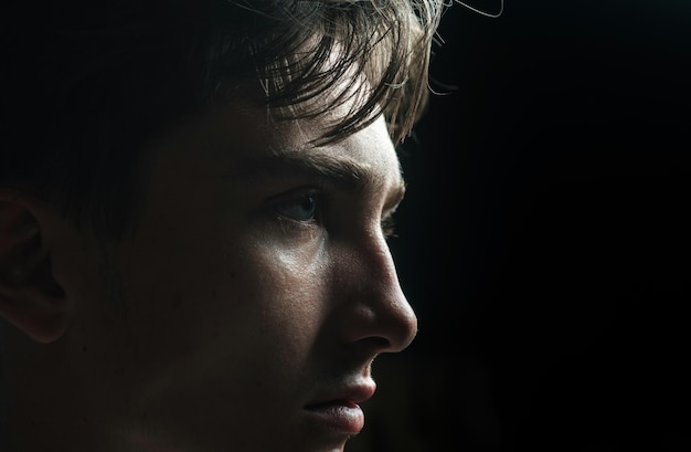 Close up portrait of young man Handsome guy face on black