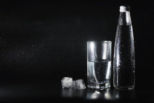 Close up pouring purified fresh drink water from the bottle on table in living room