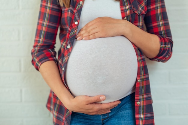 Close up Pregnant woman feeling happy love at home while taking care of her child.