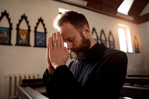 Close up on priest praying