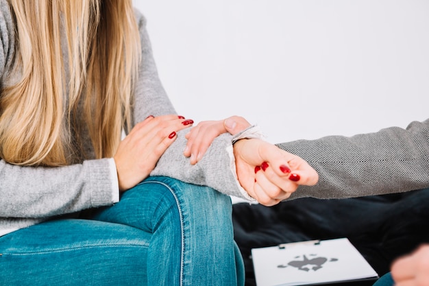 Close-up of psychologist giving support to the female patient