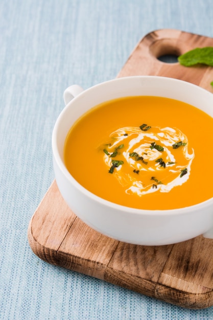 Close up of pumpkin soup in white bowl