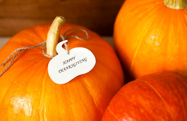 close-up of pumpkins with a note in the form of a pumpkin and text