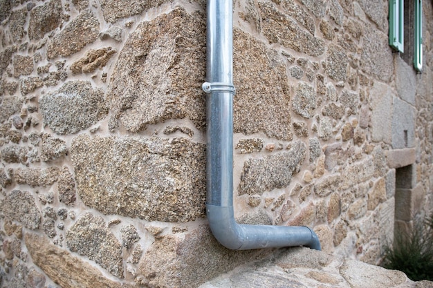 Photo close up of rain water draining gutter of a antique stone house galicia spain