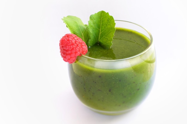 Close-up of raspberry with drink against white background